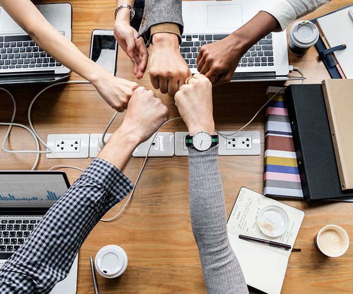 colleagues-giving-fist-bump 1